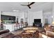 Bright living room with dark wood floors, stylish furniture, and views through arched doorway at 16662 S 37Th Way, Phoenix, AZ 85048