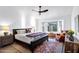 Bright main bedroom boasts a comfortable bed, bay windows, ceiling fan, and wood-look floors at 16662 S 37Th Way, Phoenix, AZ 85048