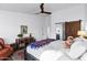 Bright main bedroom features a sliding barn door to the en-suite bathroom and wood-look floors at 16662 S 37Th Way, Phoenix, AZ 85048