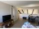 Spacious living area with tile floors, a television, and loft access at 1831 W Mulberry Dr # 241, Phoenix, AZ 85015