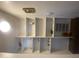 Built-in white shelving for storage and display, illuminated by a ceiling light at 1831 W Mulberry Dr # 241, Phoenix, AZ 85015