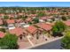 Overhead view of a residential community with homes, mature trees, streets, and mountain views in the background at 1910 E Citation Ln, Tempe, AZ 85284