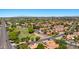 An aerial scene captures a residential area, RV parking, and terracotta-roofed houses under a clear blue sky at 1910 E Citation Ln, Tempe, AZ 85284