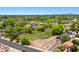 A neighborhood is pictured from above, showcasing lush landscaping, RV parking, and residences with terracotta roofs at 1910 E Citation Ln, Tempe, AZ 85284