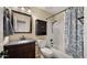 Cozy bathroom with custom sink, wood cabinet, and shower with stylish curtain at 1910 E Citation Ln, Tempe, AZ 85284