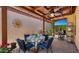 Inviting covered patio with dining table, fan, grill, and garden area at 1910 E Citation Ln, Tempe, AZ 85284