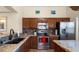 Updated kitchen featuring granite countertops, stainless steel appliances, and tile backsplash, making cooking a delight at 1910 E Citation Ln, Tempe, AZ 85284