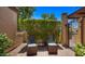 Charming patio seating area with a privacy hedge, ideal for relaxation and conversation at 1910 E Citation Ln, Tempe, AZ 85284