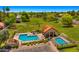 Aerial view of a community pool area with a clubhouse, swimming pools, and green lawns at 1910 E Citation Ln, Tempe, AZ 85284