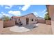 Spacious backyard featuring a covered patio, low maintenance landscaping, and privacy fencing at 19523 N Carriage Ln, Surprise, AZ 85374