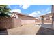 Desert backyard with low-maintenance landscaping and a covered patio and block wall fence at 19523 N Carriage Ln, Surprise, AZ 85374