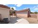 Low maintenance backyard with a covered patio structure and block wall fencing at 19523 N Carriage Ln, Surprise, AZ 85374