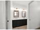 Dual sink bathroom vanity featuring framed mirrors and modern lighting, blending style and functionality at 19523 N Carriage Ln, Surprise, AZ 85374