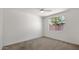 Bedroom with carpet flooring, ceiling fan, and window at 19523 N Carriage Ln, Surprise, AZ 85374