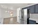 Open kitchen view with stainless steel refrigerator and a glimpse into an adjacent dining area at 19523 N Carriage Ln, Surprise, AZ 85374