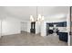 An open-concept view of a stylish kitchen with stainless steel appliances and adjacent living space at 19523 N Carriage Ln, Surprise, AZ 85374