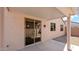 Covered patio with access to the home through a sliding glass door and multiple windows at 19523 N Carriage Ln, Surprise, AZ 85374
