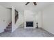 Bright living room featuring a fireplace, ceiling fan, and staircase leading to the upper level at 1961 N Hartford St # 1055, Chandler, AZ 85225