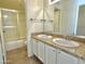 Bathroom with tile floor, granite counters and shower with glass door at 2100 W Lemon Tree Pl # 59, Chandler, AZ 85224