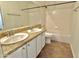 Bright bathroom with dual sinks, granite countertops, and tub with shower at 2100 W Lemon Tree Pl # 59, Chandler, AZ 85224
