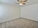 Simple bedroom with neutral walls, carpet and a ceiling fan with light fixture at 2100 W Lemon Tree Pl # 59, Chandler, AZ 85224
