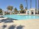 Community pool view with bright turquoise water and desert landscape at 2100 W Lemon Tree Pl # 59, Chandler, AZ 85224