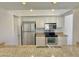 Modern kitchen with stainless steel appliances, granite countertops, and white cabinetry at 2100 W Lemon Tree Pl # 59, Chandler, AZ 85224