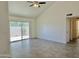 Bright living room featuring neutral paint, tile flooring, sliding glass doors, and a ceiling fan at 2100 W Lemon Tree Pl # 59, Chandler, AZ 85224