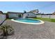 Wide angle view of a backyard with a pool, putting green, and desert landscaping at 2111 N Van Ness Ave, Tempe, AZ 85288