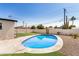 Spacious backyard featuring a swimming pool, artificial turf putting green, and desert landscaping at 2111 N Van Ness Ave, Tempe, AZ 85288