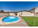 Fenced backyard featuring a bright blue pool and an artificial turf putting green at 2111 N Van Ness Ave, Tempe, AZ 85288