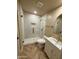 Bathroom featuring tiled shower with pebble floor, modern vanity, and gold fixtures at 2111 N Van Ness Ave, Tempe, AZ 85288