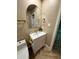 Stylish bathroom featuring a modern vanity, gold fixtures, and herringbone flooring at 2111 N Van Ness Ave, Tempe, AZ 85288