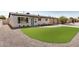 Charming one story home with an artificial lawn, desert landscaping, and a covered carport at 2111 N Van Ness Ave, Tempe, AZ 85288