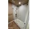 Shower featuring stone floor, tiled walls, and gold fixtures at 2111 N Van Ness Ave, Tempe, AZ 85288