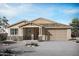Inviting single-Gathering home featuring a two-car garage, stone accents, and a covered porch at 23040 E Watford Dr, Queen Creek, AZ 85142