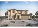 Charming two-story home featuring a two-car garage, desert landscaping, and a welcoming covered entryway at 23055 E Watford Dr, Queen Creek, AZ 85142