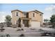 Charming two-story home with a neutral color scheme, shuttered windows and a desert landscape at 23056 E Watford Dr, Queen Creek, AZ 85142