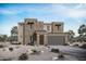 Modern two-story home featuring a two-car garage, desert landscaping, and a neutral color palette against a blue sky at 23064 E Watford Dr, Queen Creek, AZ 85142