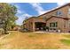 Stucco home featuring a spacious backyard with a covered patio and stone columns at 23126 N 45Th Pl, Phoenix, AZ 85050