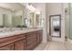 Primary bathroom featuring dual sinks with granite countertops and a decorative mirror at 23126 N 45Th Pl, Phoenix, AZ 85050
