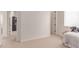 Well-lit bedroom with neutral carpeting, white trim and doors, and view into hallway at 23126 N 45Th Pl, Phoenix, AZ 85050