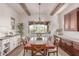 Spacious dining room showcases wood beam ceilings and a view of the outdoor patio at 23126 N 45Th Pl, Phoenix, AZ 85050