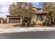 Beautiful home with manicured landscaping, mature flowering trees, and brick paver driveway at 23126 N 45Th Pl, Phoenix, AZ 85050