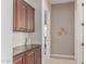 Hallway featuring brown cabinets and brown countertops with decorative wall hangings at 23126 N 45Th Pl, Phoenix, AZ 85050