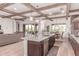 Open kitchen featuring stainless appliances, granite counters, large island, and wood beam ceilings at 23126 N 45Th Pl, Phoenix, AZ 85050
