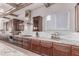 This gourmet kitchen features wood beams, granite countertops, and stainless steel appliances at 23126 N 45Th Pl, Phoenix, AZ 85050