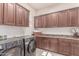 Well-equipped laundry room boasts ample cabinetry, counter space, washer and dryer at 23126 N 45Th Pl, Phoenix, AZ 85050