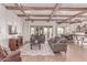 Spacious living room with wood beam ceilings, hardwood floors, and a decorative fireplace at 23126 N 45Th Pl, Phoenix, AZ 85050