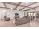 Elegant living room featuring hardwood floors, wood beam ceilings, and a decorative fireplace at 23126 N 45Th Pl, Phoenix, AZ 85050